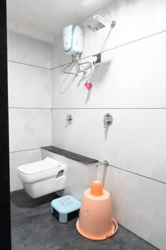 a bathroom with a toilet and a camera on the wall at Hotel Crystal in Ahmedabad