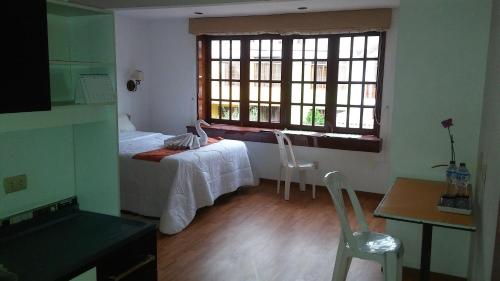 a small room with a bed and a window at Familia Tome in Chaclacayo