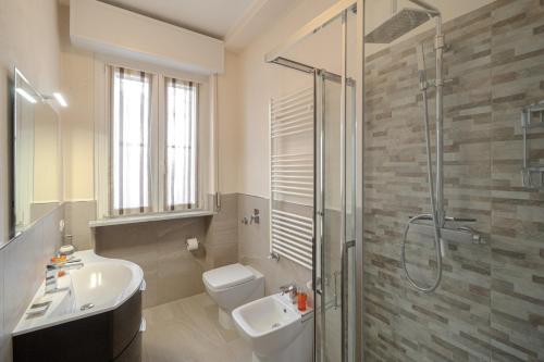 a bathroom with a toilet and a sink and a shower at Casa Lella in Novara