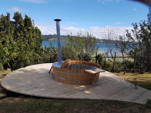 a large wooden tub sitting on top of a wooden table at Casa Bordemar in Castro
