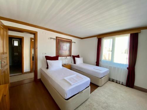 a bedroom with two beds and a window at Sunset House in Selçuk