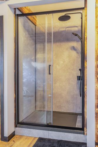 a glass door of a shower in a room at Osé in Chênet