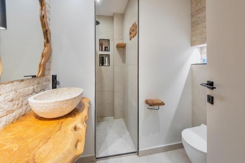 a bathroom with a vessel sink and a shower at Corfu nest apartment in Ágios Rókkos