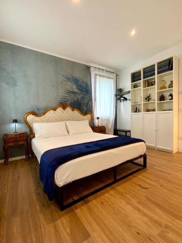 a bedroom with a large bed with a blue blanket at Romantic suite between Venice and Padua in Dolo