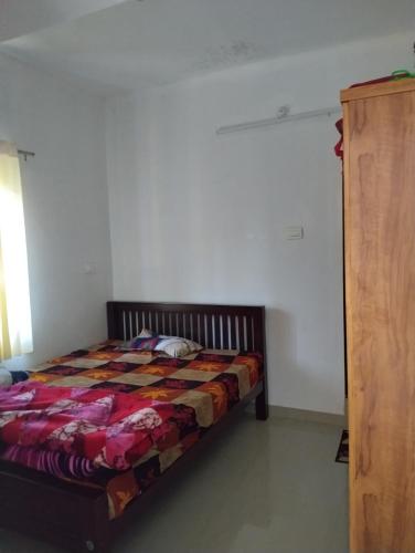 a bedroom with a bed in a room at Grace villa Homestay in Vattavada