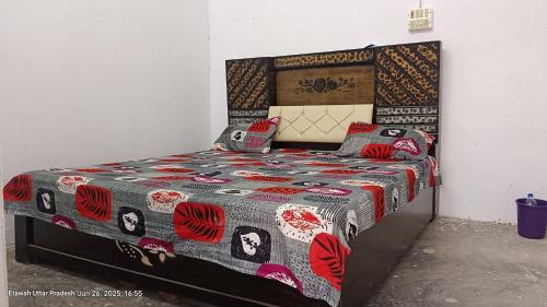 a bed with a quilt and pillows on it at The Dream Hotel And Rooms in Etāwah