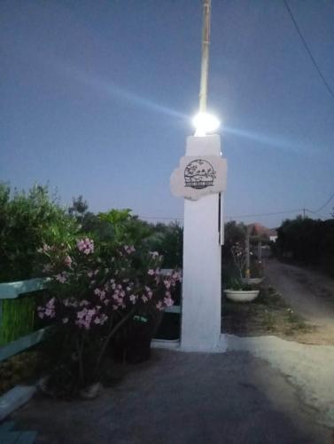 a clock tower with a light on top of it at MANOS Small House Kouremenos in Palekastron