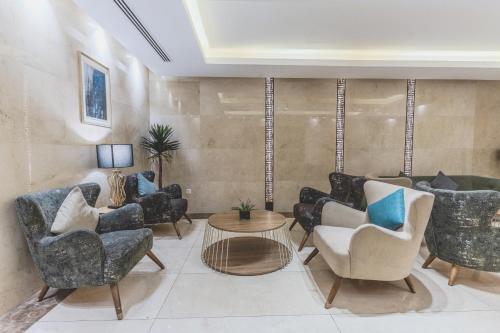 a living room with chairs and a table at Lacosta Hotel in Aqaba
