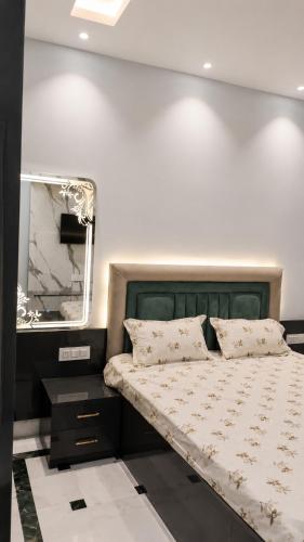 a bedroom with a bed and a mirror at Moti Manas Mansion - A Homestay in Gwalior in Gwalior