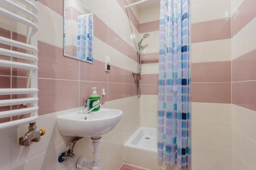 a bathroom with a sink and a shower at Hostel Tara in Kraków