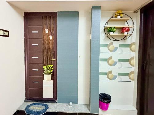 a hallway with a blue and white wall at Divine Homestay by EDAC in Chidambaram