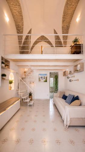 a large room with a bed and a loft at 4sisters' Open Space in Aradeo