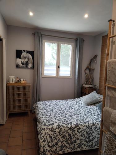 a bedroom with a bed and a window at Ancienne Gare Camargue in Arles