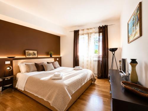 a bedroom with a large bed and a window at Taormina Panoramic Apartment - Taormina Holidays in Taormina