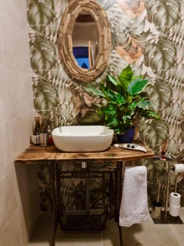 a bathroom with a sink and a mirror at Cortijo Paraiso Pool & Tropical Garden Oasis in Cúllar de Baza