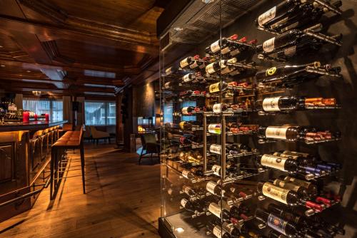 a wall of wine bottles in a wine cellar at The Christiania Mountain & Spa Resort in Zermatt