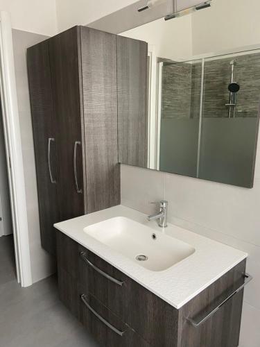 a bathroom with a sink and a mirror at B&B Il Viale in Ponte dellʼOlio