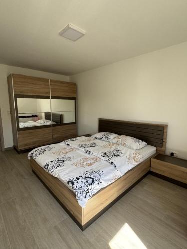 a bedroom with a large bed and a large mirror at Bela Bar in Pečurice
