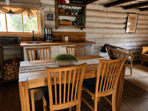 a dining room with a wooden table and chairs at Sepasauna holiday house in Joaveski