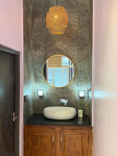 a bathroom with a sink and a mirror at Bella Casa in Vagamon