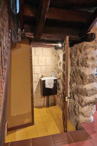 a bathroom with a sink in a stone wall at La Platería I in Mambrilla de Castrejón