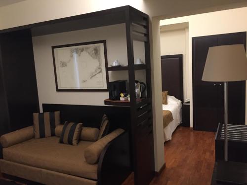 a living room with a couch and a bedroom at Terrazza Marconi Hotel&Spamarine in Senigallia