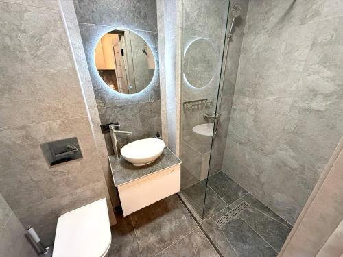 a bathroom with a sink and a mirror at VELAR Apartment in Skhidnitsa