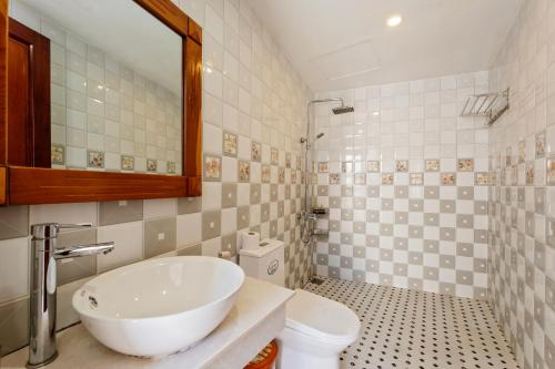 a bathroom with a sink and a toilet at Hoi An Legend Connect Villa in Hoi An