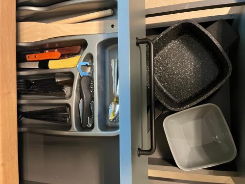 a drawer filled with utensils and a spatula at Pavasari in Cēsis