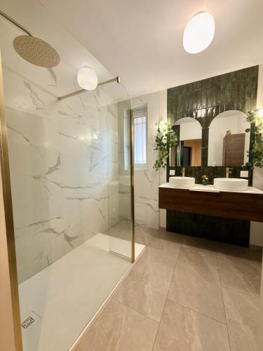a bathroom with two sinks and two mirrors at T4 moderne parking Théodore Bac - DABNB in Limoges
