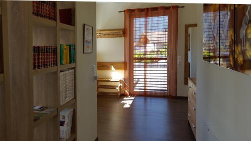 a room with a hallway with a door and a room with a table at Ferienwohnung Dolomitenpanorama in Oberlienz