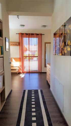 a living room with a large window and a rug at Ferienwohnung Dolomitenpanorama in Oberlienz