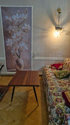 a living room with a coffee table next to a couch at Guest House Teo in Tbilisi City
