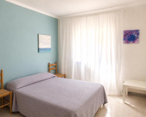 a bedroom with a bed and a large window at Rooms in Palma Center in Palma de Mallorca