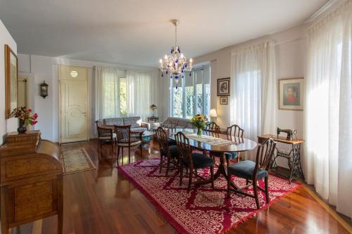 a living room with a dining table and chairs at Villa Magnolia in Ioannina