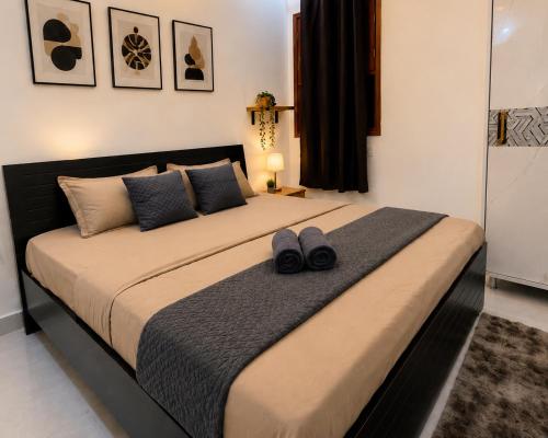 a bed with a pair of shoes sitting on top of it at Casa Nova Stays in Dehradun