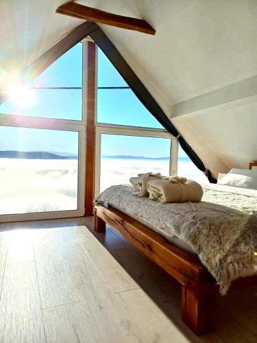 a bed in a room with a large window at Relax house Aurora in Jasenovica