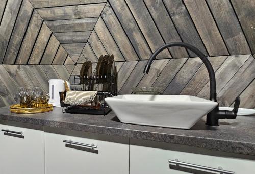 a white sink on a counter in a kitchen at Trys su puse upės in Dzidai