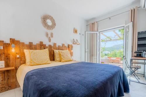 a bedroom with a large bed with a blue blanket at La Casa del Burro in Nerja