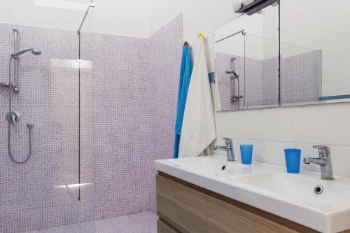 a bathroom with a sink and a shower at Appartamenti Francesco in Catania