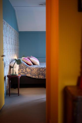 a bedroom with a bed with pillows on it at Buiteninn in Rijssen