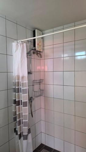 a bathroom with a shower with a shower curtain at Avatara A condominium C41 with sea view in Ban Tha Fat