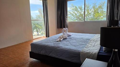 a bedroom with a bed with a stuffed animal on it at Avatara A condominium C41 with sea view in Ban Tha Fat