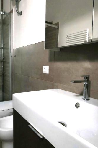 a bathroom with a white sink and a toilet at TOSCANA HOME in Ravenna