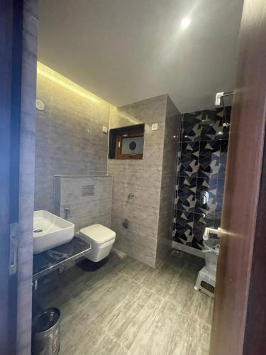 a bathroom with a white toilet and a sink at Casa Sevara Hotel in Vagator