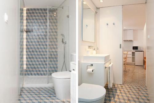 a bathroom with a toilet and a glass shower at Alfama Yellow House in Lisbon