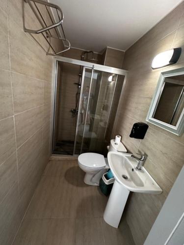 a bathroom with a toilet and a sink at Golden Hill Hotel in Rizokarpaso