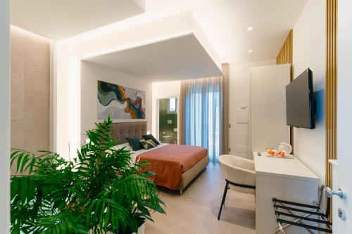 a bedroom with a bed and a chair in a room at B&B Palmares Rooms & Suites in Taviano