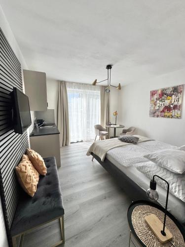 a bedroom with a bed and a tv in it at Kal's Studio Apartment Salzburg in Salzburg