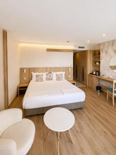 a bedroom with a bed and two tables and chairs at Family Hotel Berlin Beach Sveti Vlas in Sveti Vlas